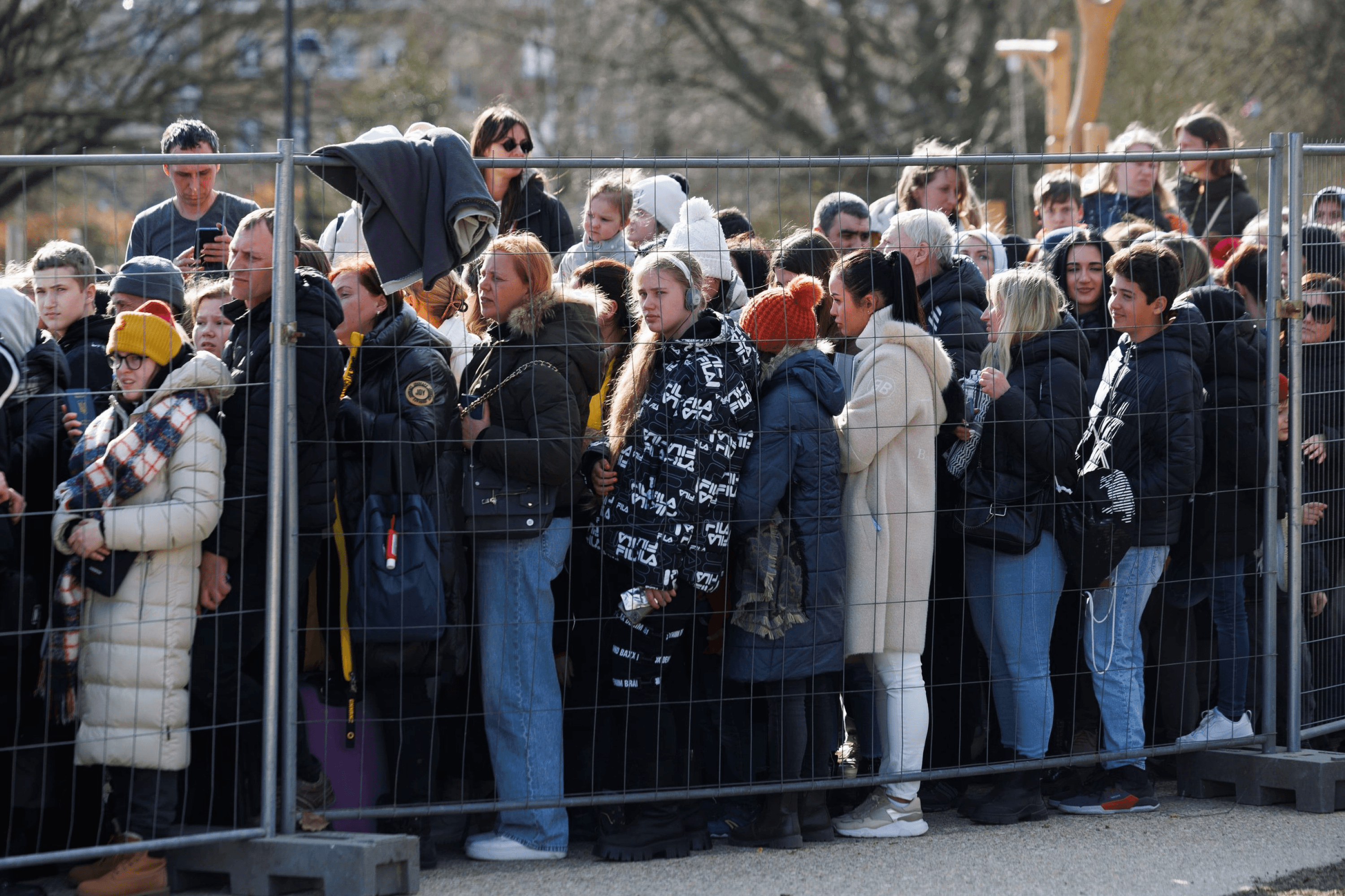 Ukrainian refugees queue at a registration center in Brussels, Belgium. 2022.
