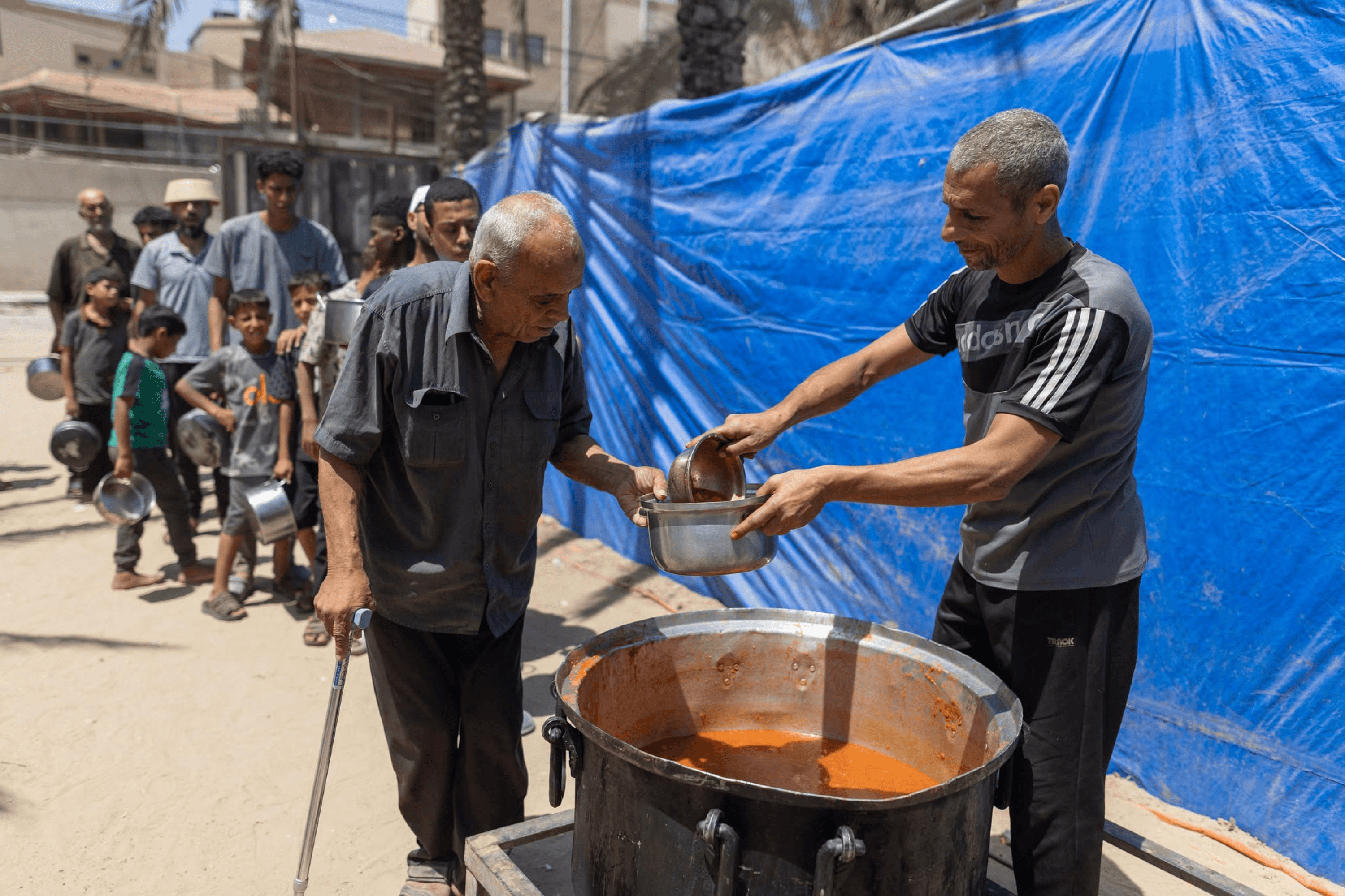 Raed Hassan helps distribute World Central Kitchen food to displaced families in Deir al-Balah, Gaza Strip. July 16, 2026.