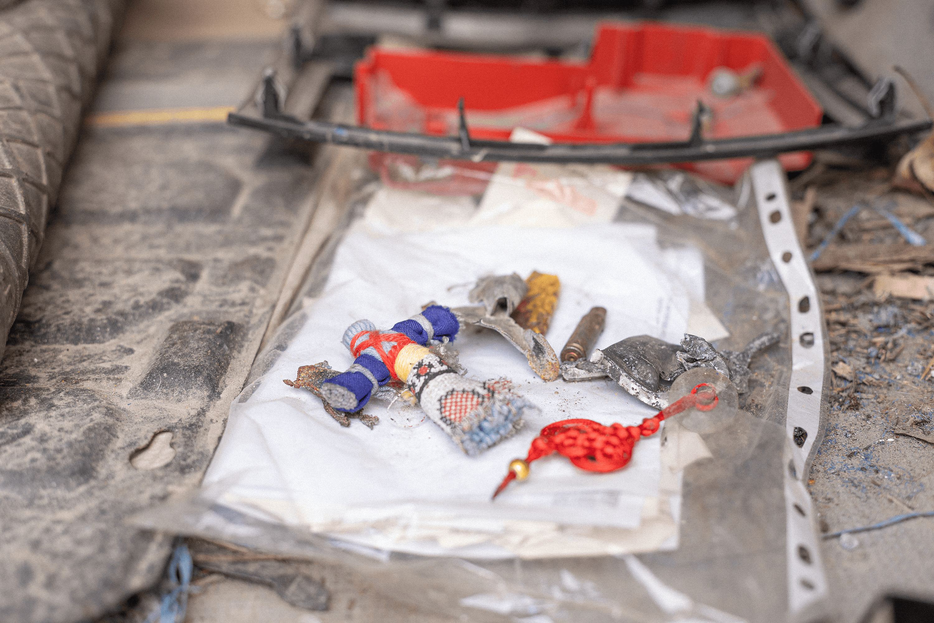 In the van, Leonid keeps items from his journeys—a traditional motanka doll, shell casings, and fragments of the drone that destroyed the vehicle.