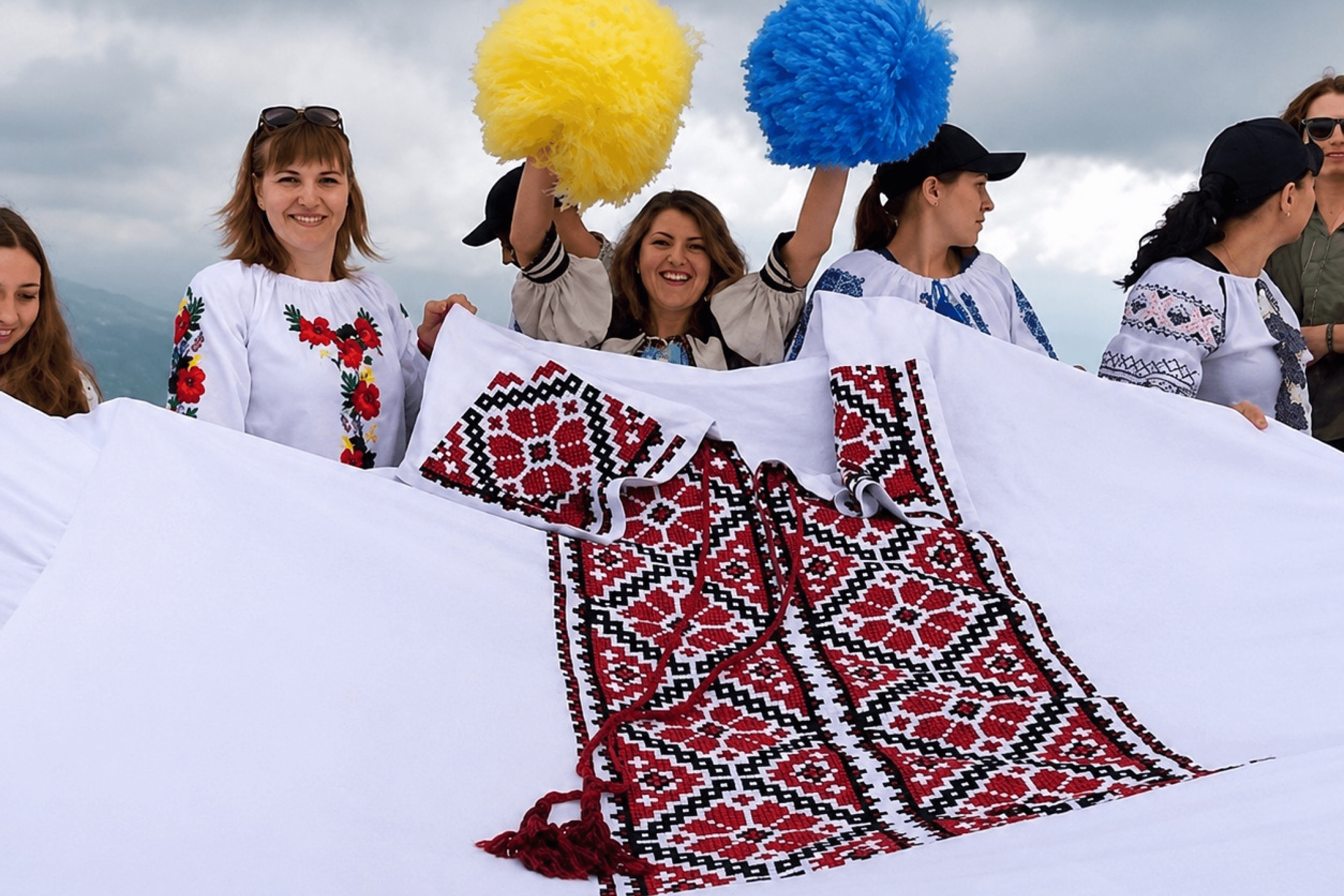 Participants of the rally hold a giant vyshyvanka during the announcement of “Wear Vyshyvankas: Heritage Under Fire.” Canada. May 2026.