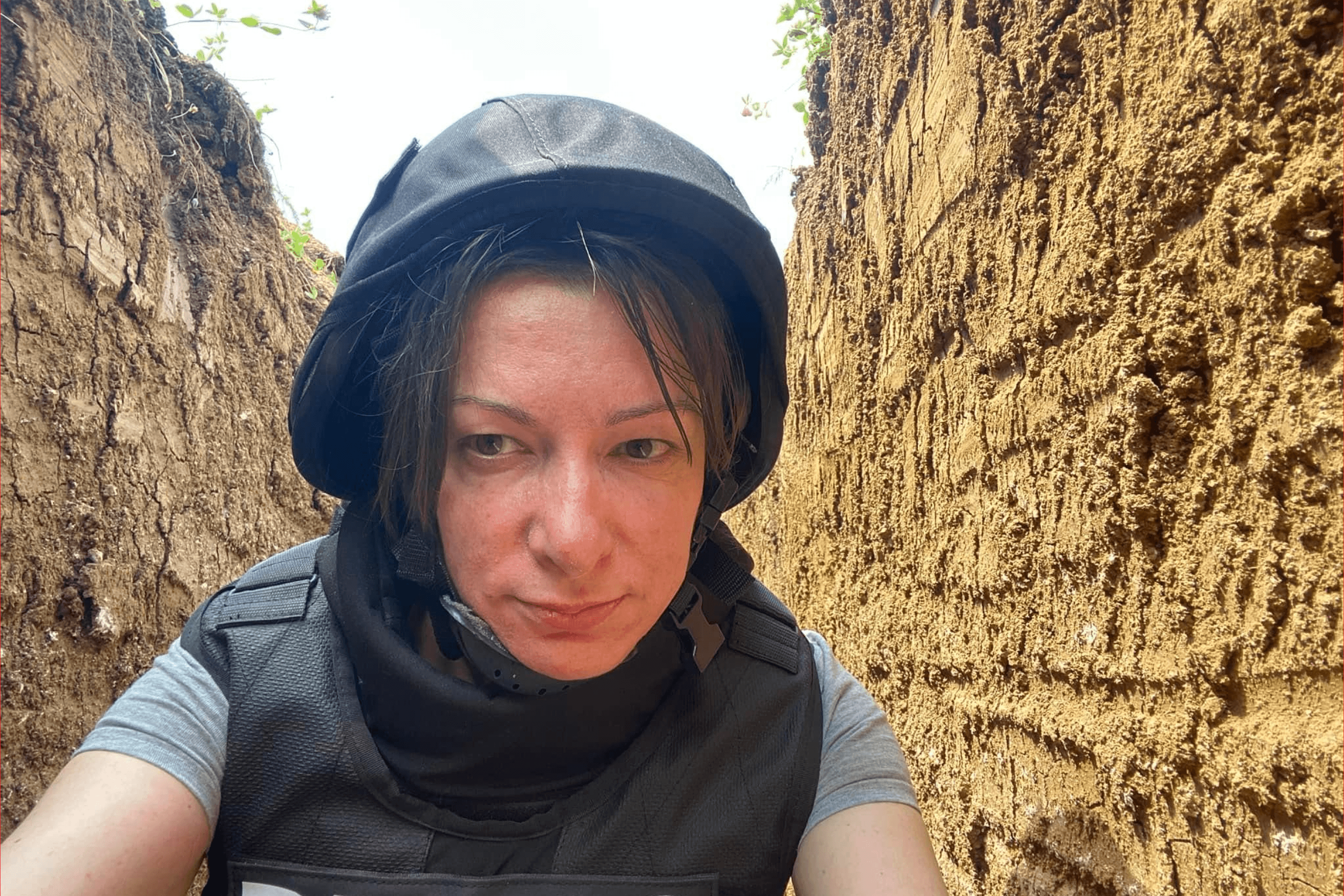 Kristina Berdynskykh in a trench while reporting from the front. June 2022.
