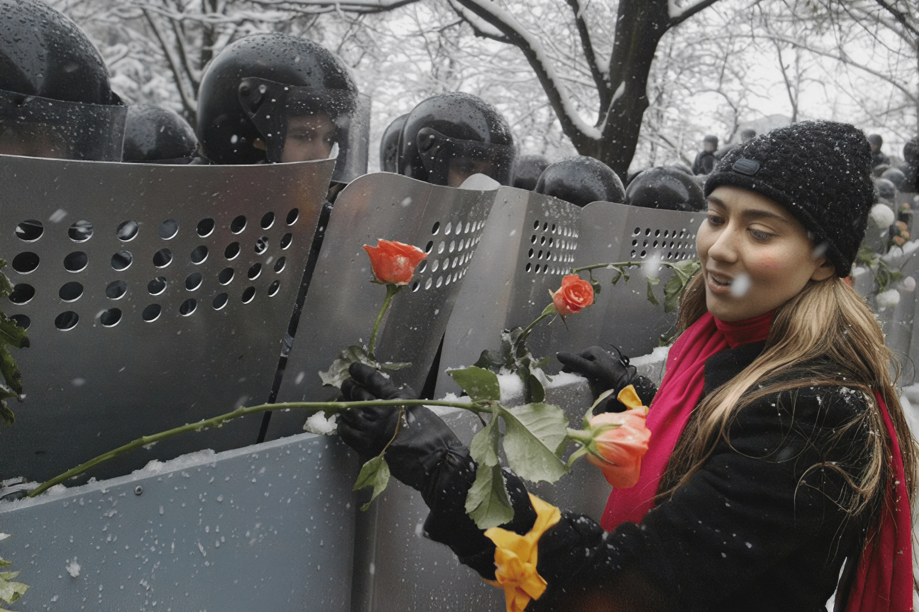 A girl attaches flowers to police shields during the Orange Revolution. Kyiv, December 1, 2004.