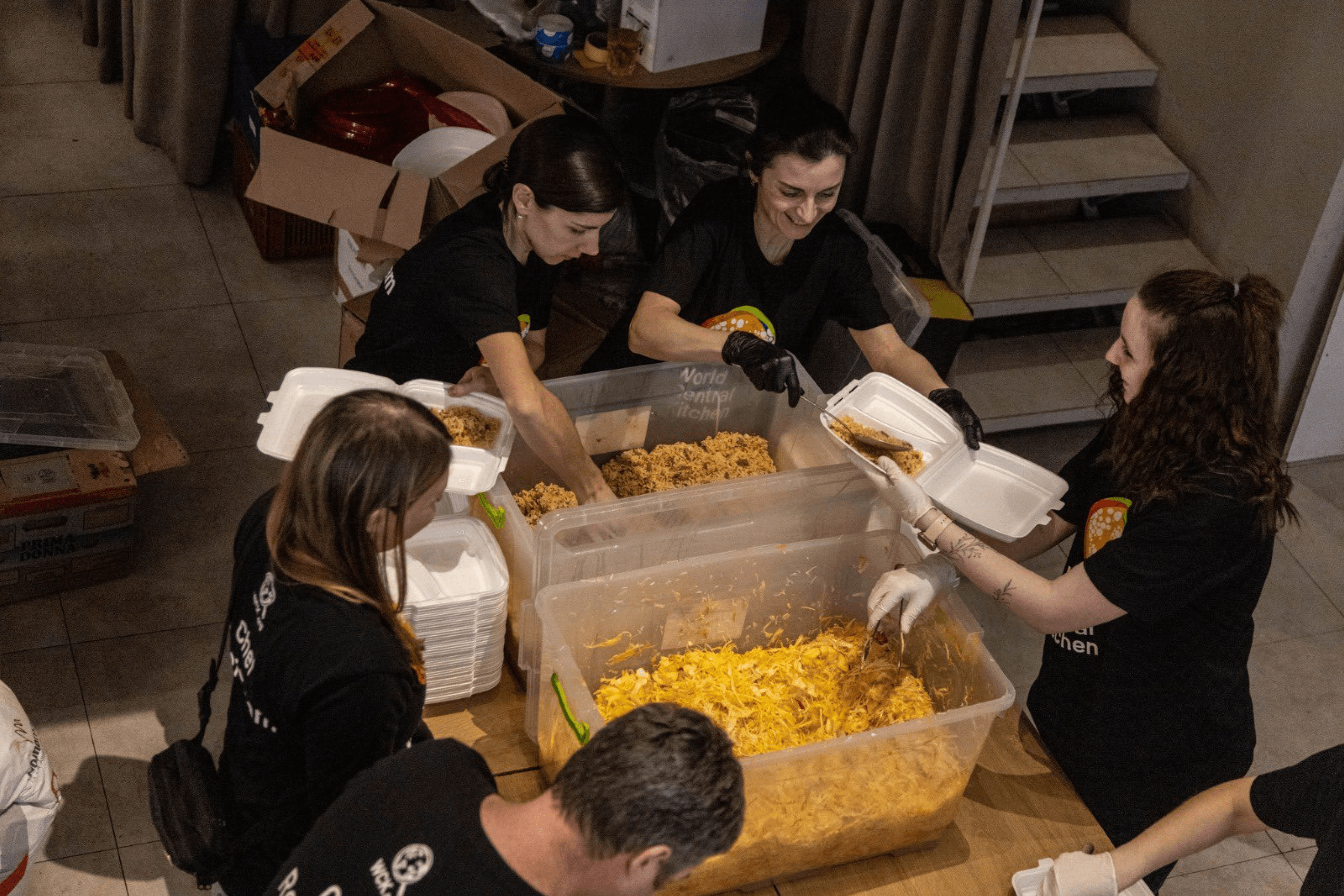 The team at Lviv’s Pasta Cafe restaurants, partners of World Central Kitchen, prepares and packs food. Lviv, March 2022.