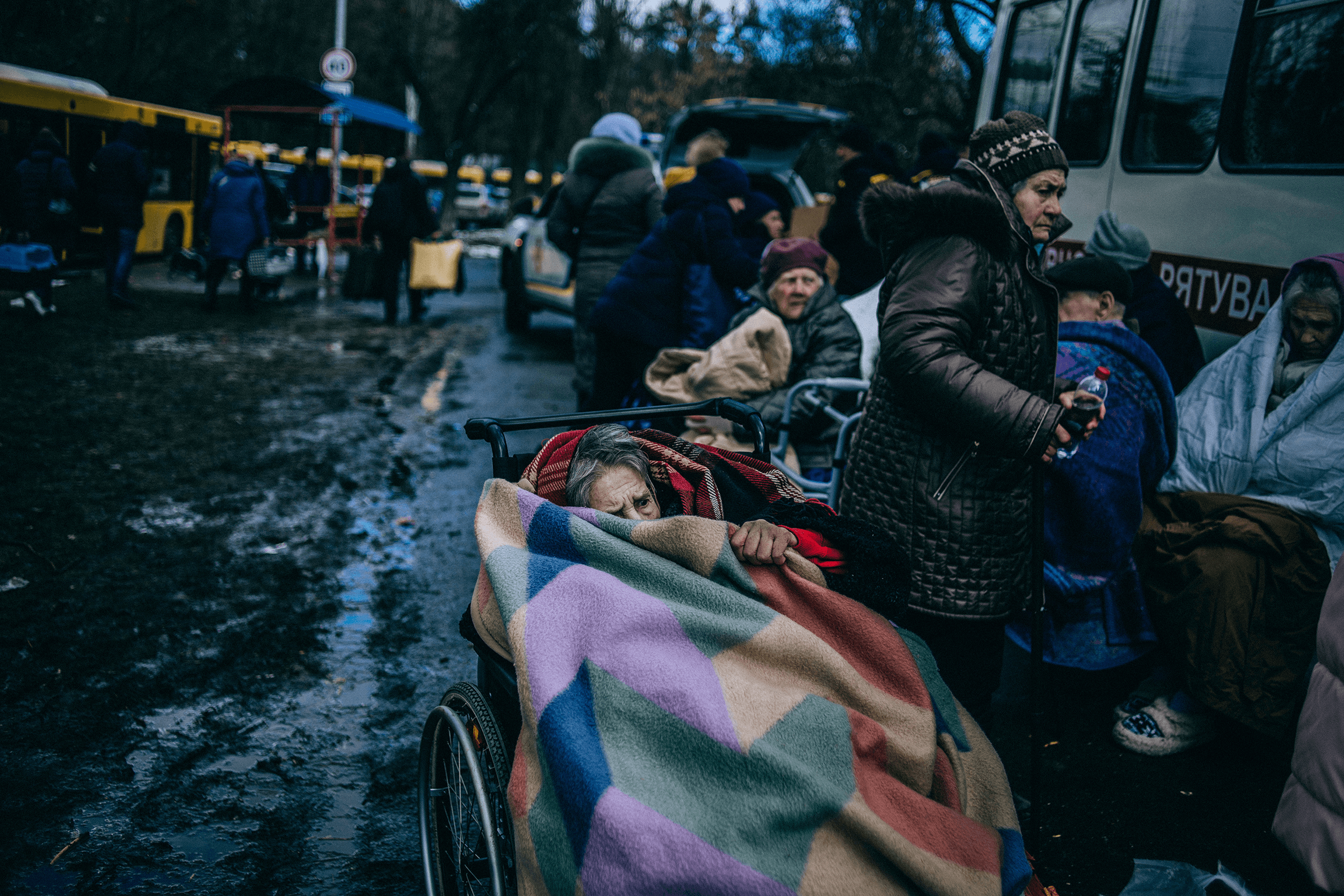 An elderly woman hides under a blanket as she is evacuated from Irpin, Ukraine. 8 March, 2022.